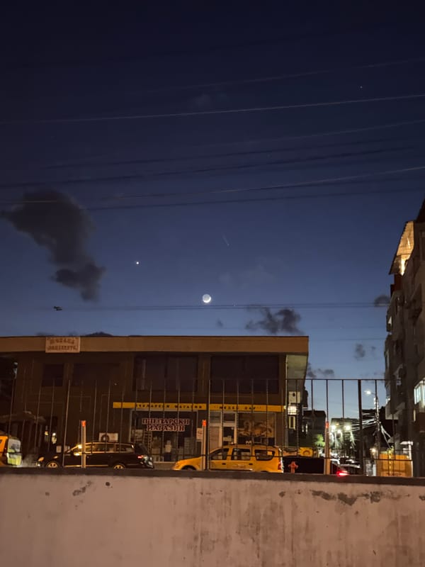 Crescent moon observed over illuminated buildings in Burgas, Bulgaria