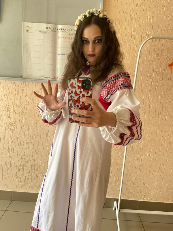 Woman poses in traditional dress in Chaikovsky, Russia