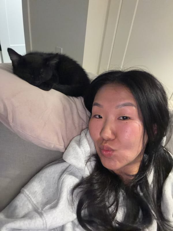 Woman spends quiet moments with black cat in New Westminster home