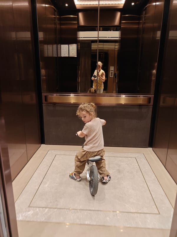 Children play at Mumbai pool facility with skyline views