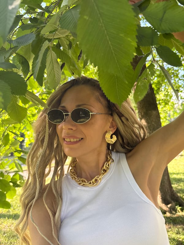 Woman takes selfies in sunny Rusanovo park