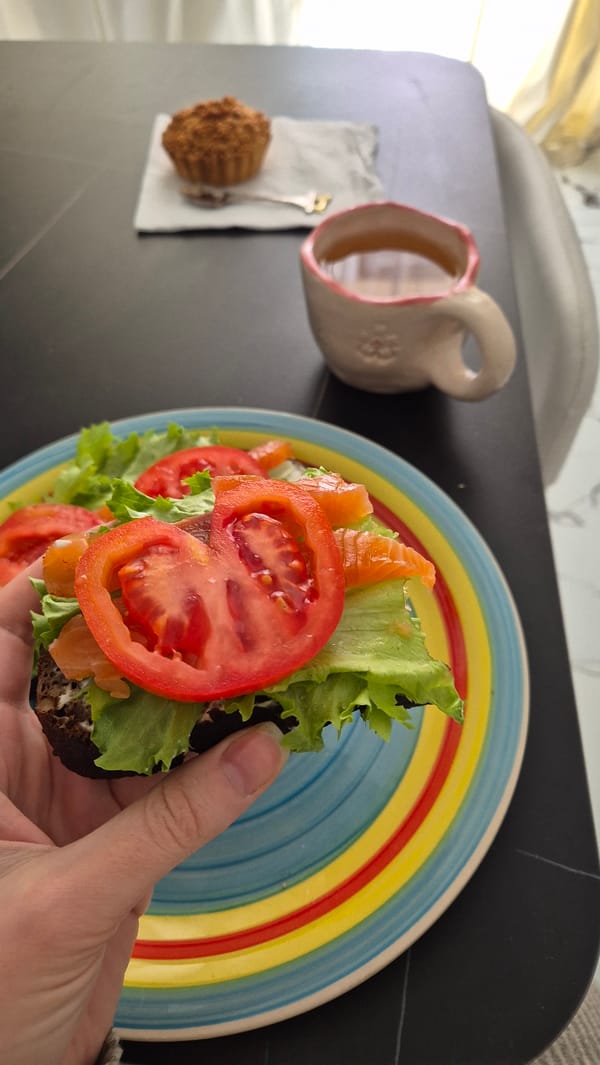 Woman enjoys salmon sandwich breakfast in Batumi restaurant