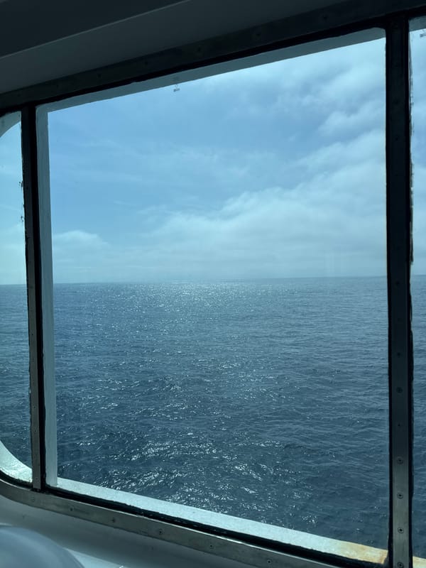 Window view captures sky and ocean scene