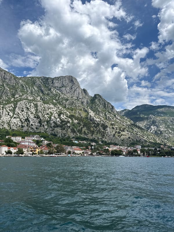 Coastal church and mountain views documented in Dobrota, Montenegro