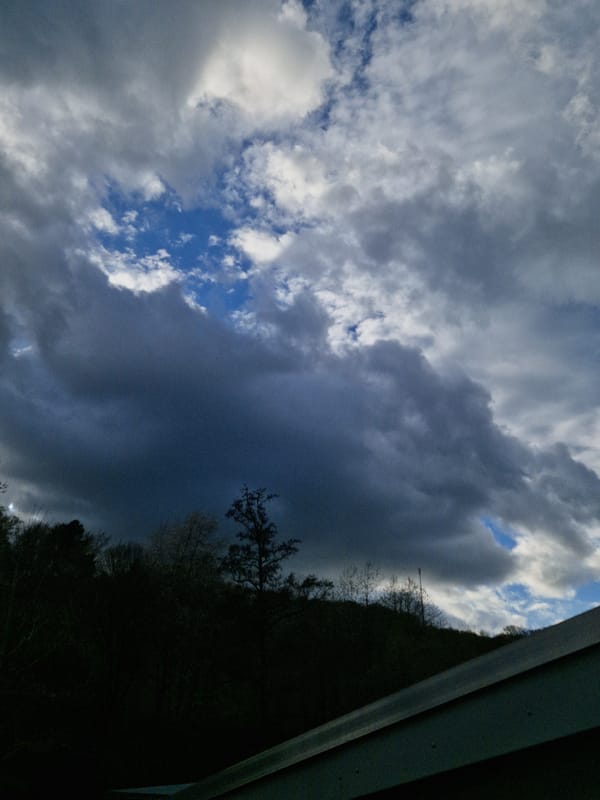 Dark clouds gather over German woodland near Leidersbach