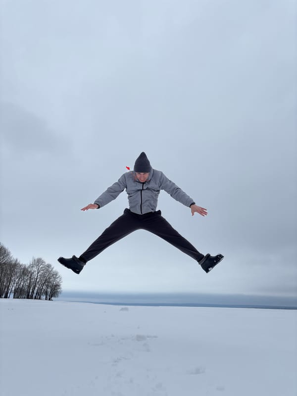 Adult and child make snow angels together in Russia