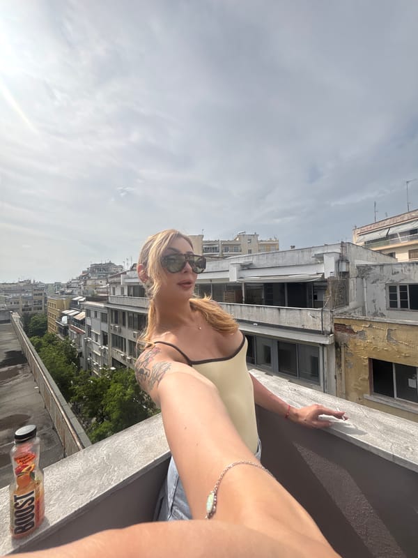 Woman photographed on Thessaloniki rooftop amid urban cityscape