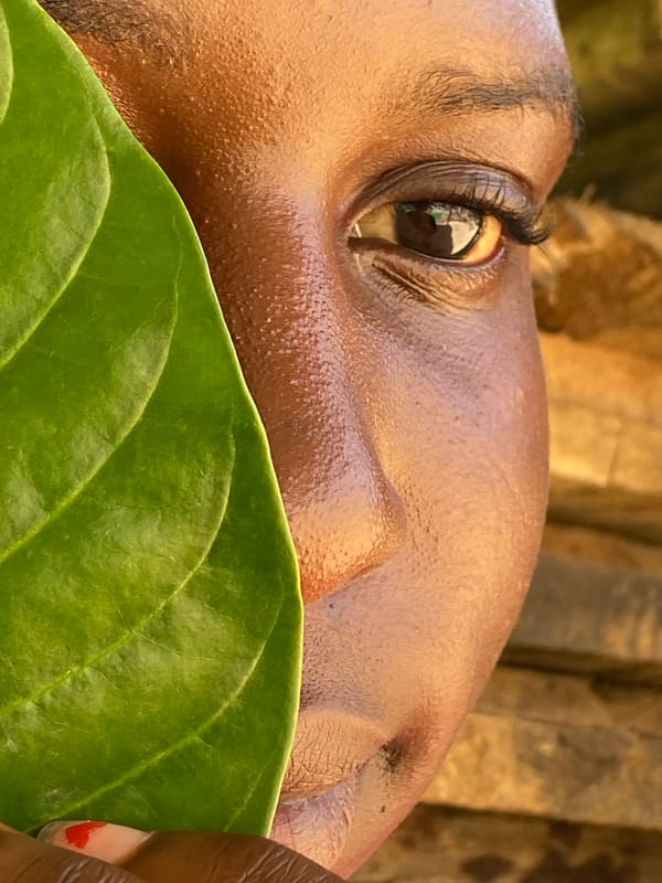 Woman poses with green leaf in artistic photos across Nigeria