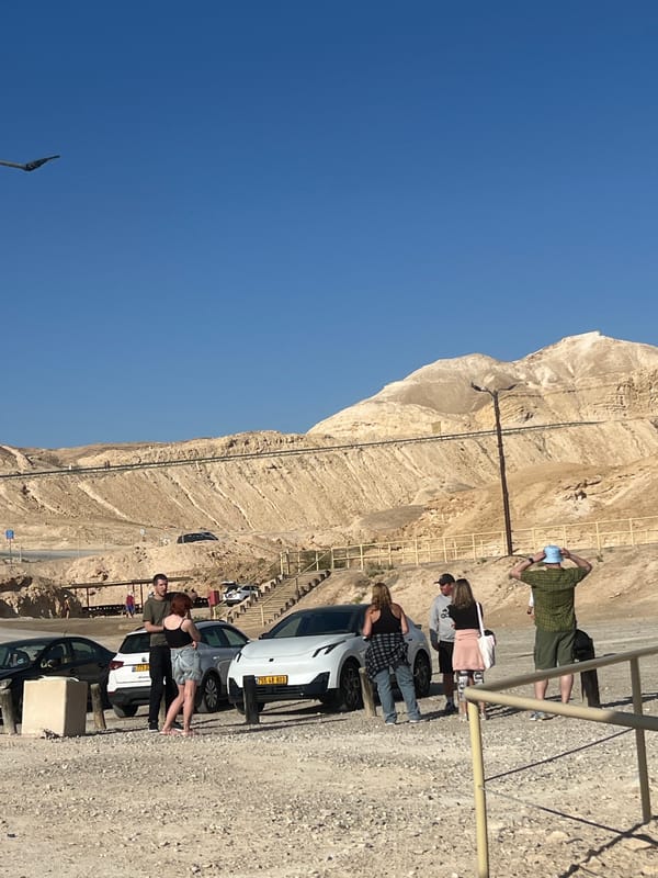 Early morning hikers gather on rocky mountainside in Israel