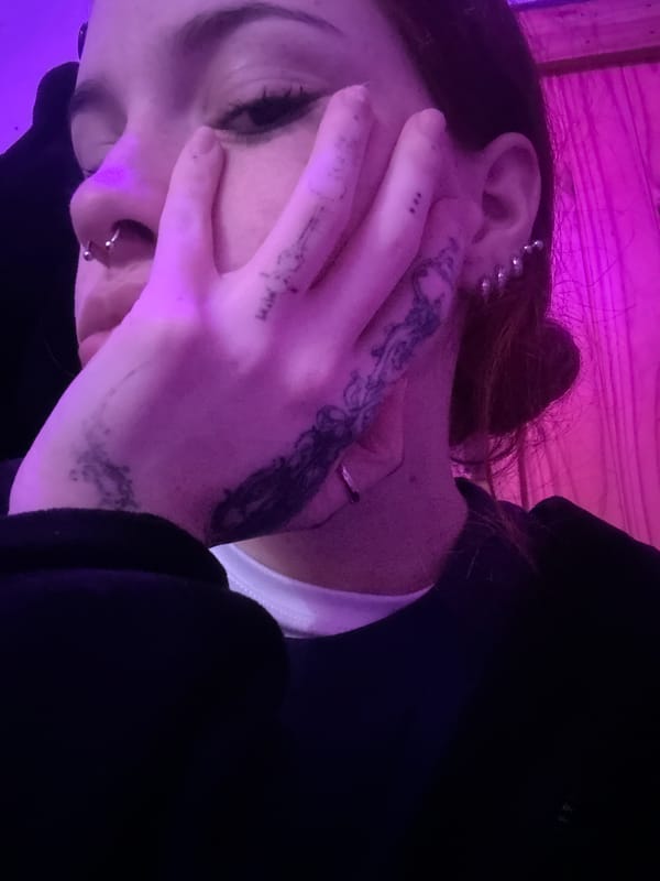Tattooed, pierced, under purple light in Buenos Aires nightlife