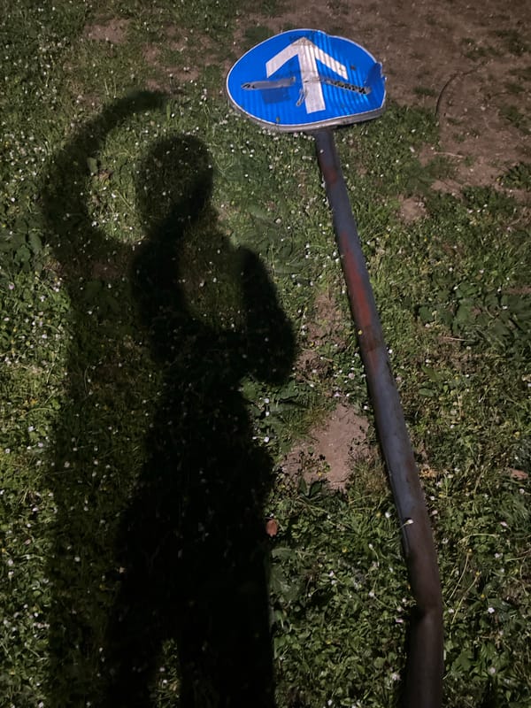 Broken directional road sign found on ground in Budva