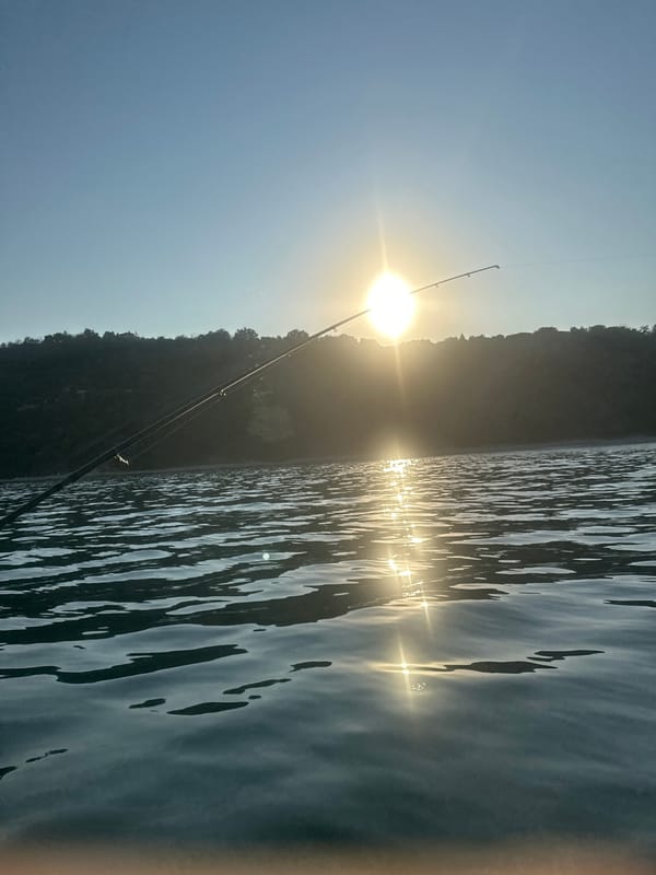 Fishing trip ends at dusk near a working harbor
