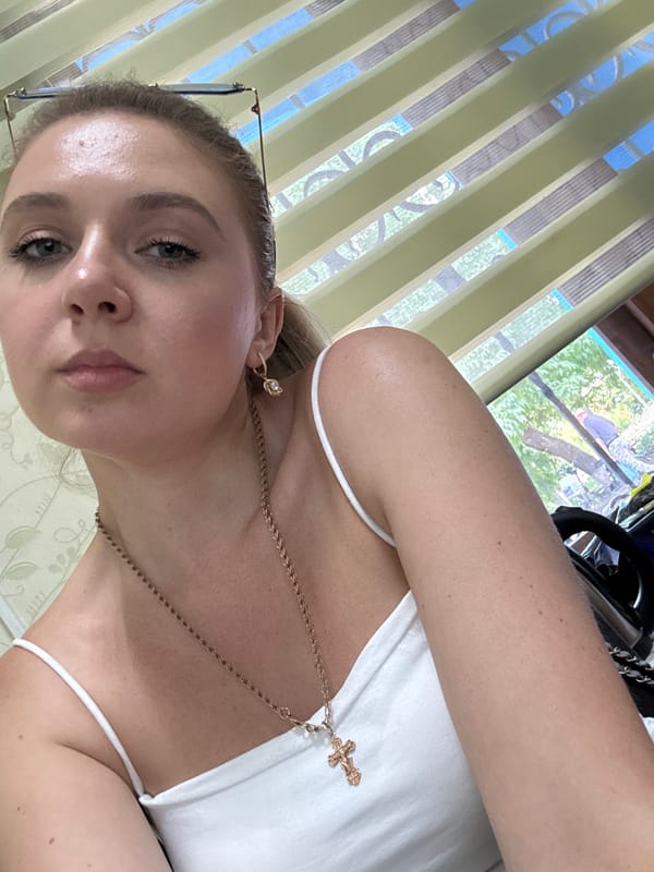 Indoor selfie session, white tank top and gold cross necklace