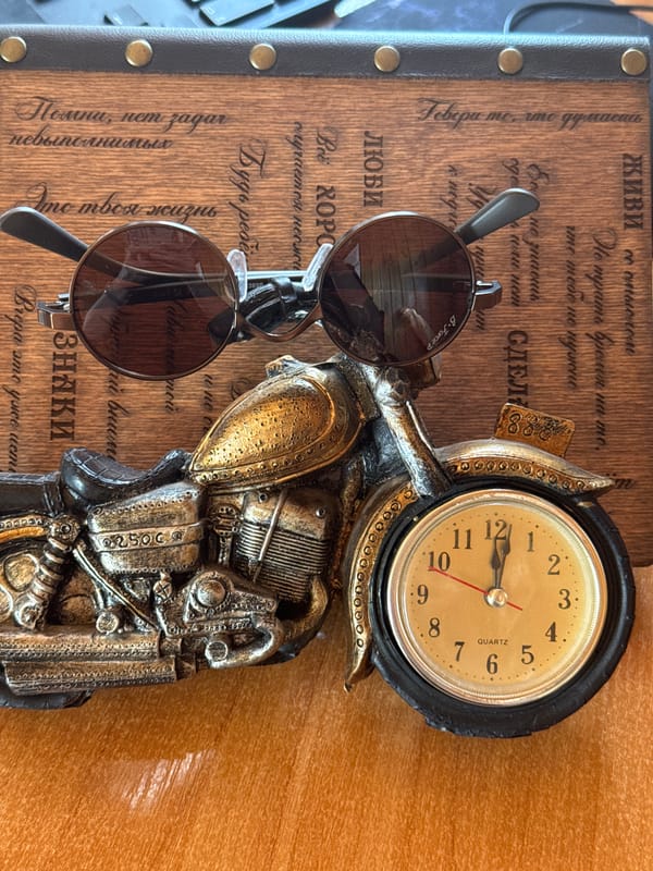 Eclectic shelf display of clocks, daggers, figurines, and collectibles