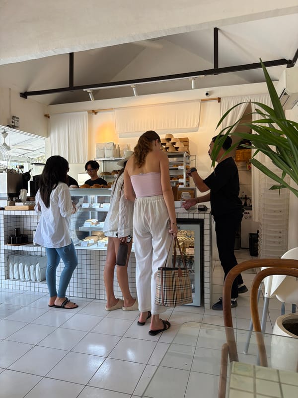 Inside and outside a busy bakery-café in Mengwi