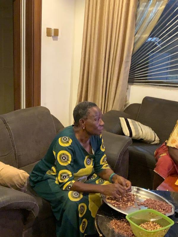 Sorting peanuts on a silver platter in a Jos living room