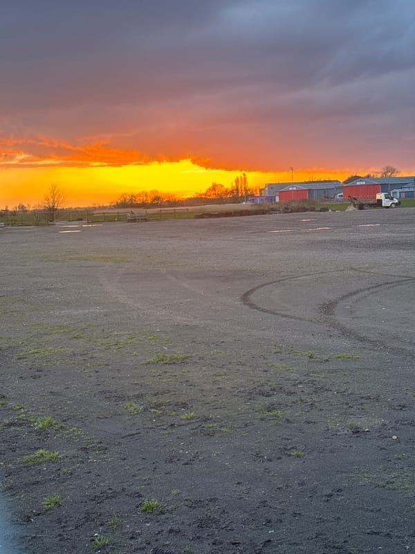 Sunset observed over wet roads in Caister-on-Sea