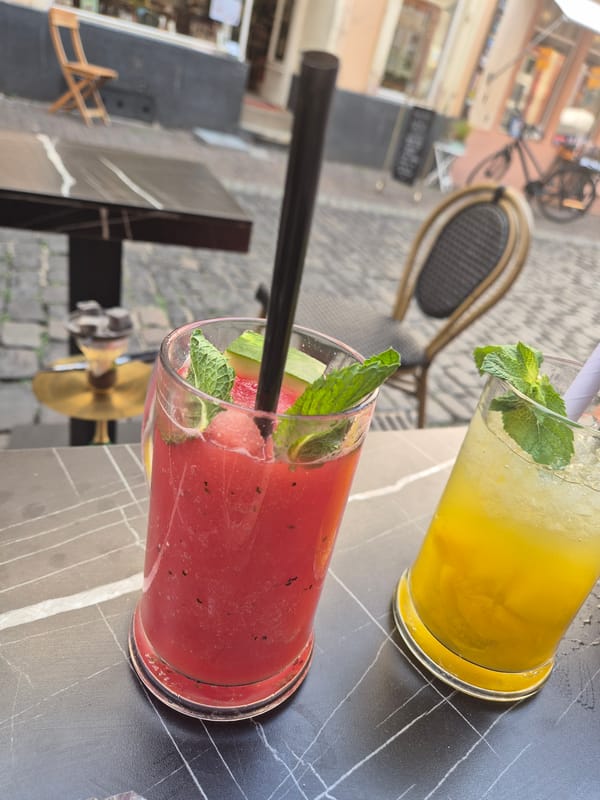 Colorful garnished drinks on a patterned outdoor table