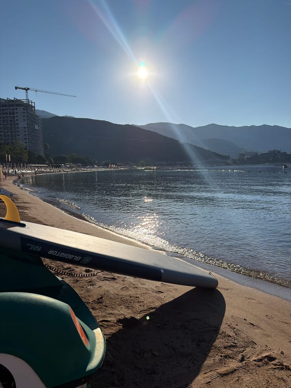 Calm morning paddleboarding at sunrise in Budva