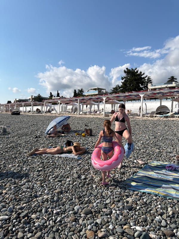 Busy summer afternoon on a Black Sea pebble beach in Sirius