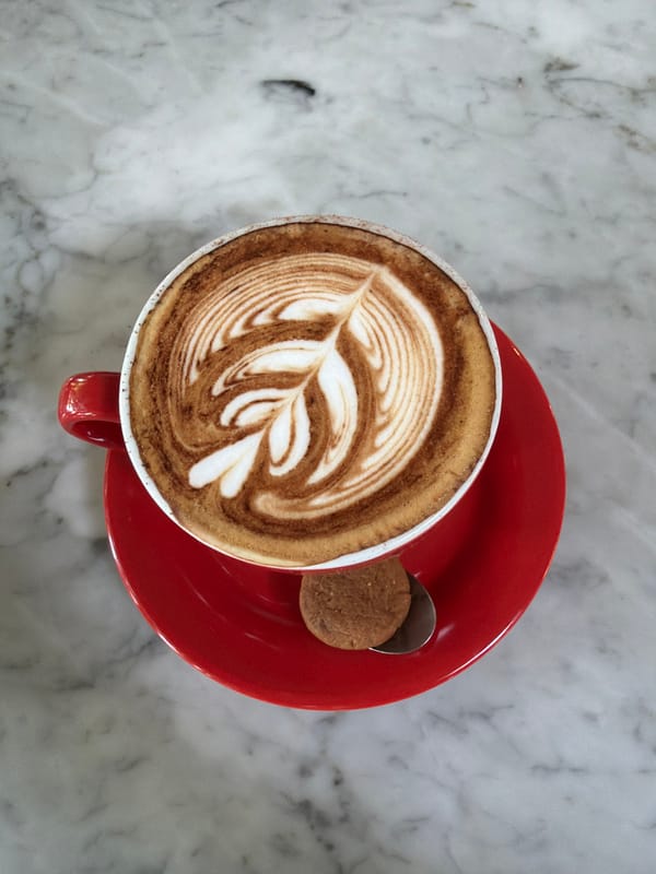 Cappuccino with latte art served in North Kuta