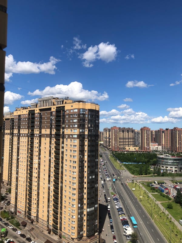 Aerial sweep of a Russian city on a partly cloudy summer day
