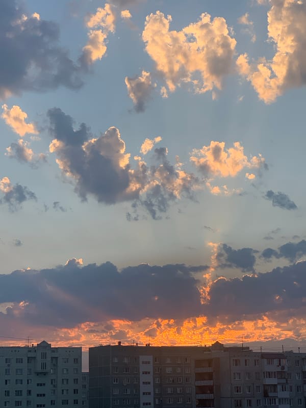 Omsk skyline at sunset, storm clouds and Soviet blocks