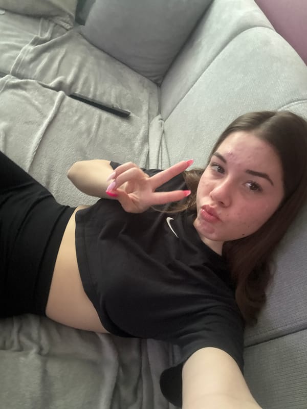 Woman takes selfie on grey sofa in Plovdiv