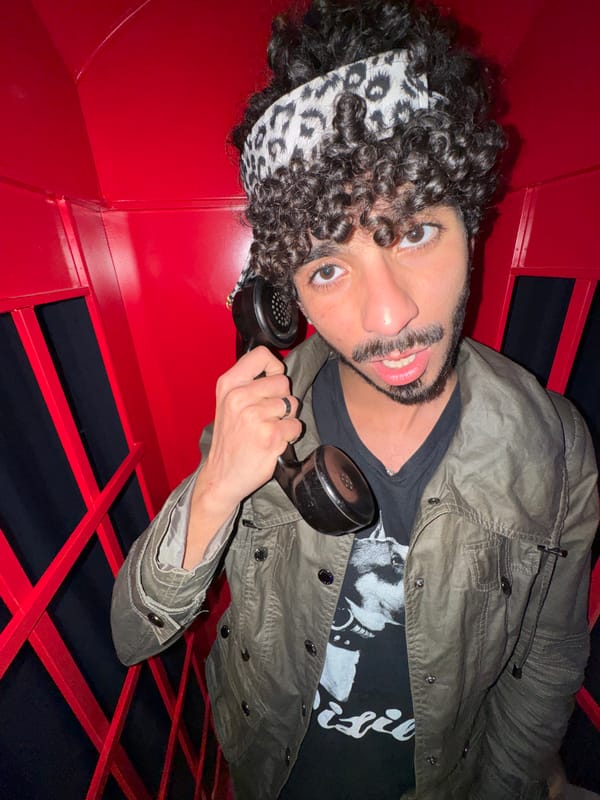 Man poses in decorated British phone booth in Créteil