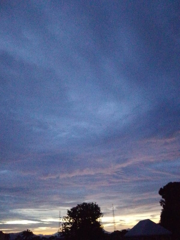 Dusk sky and streetside greenery in Serti, Nigeria