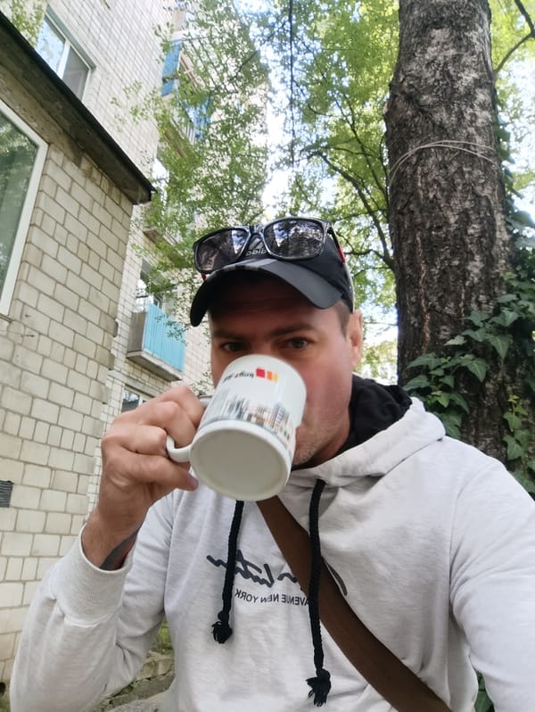 Morning coffee break in Ladyzhyn, scooter parked nearby
