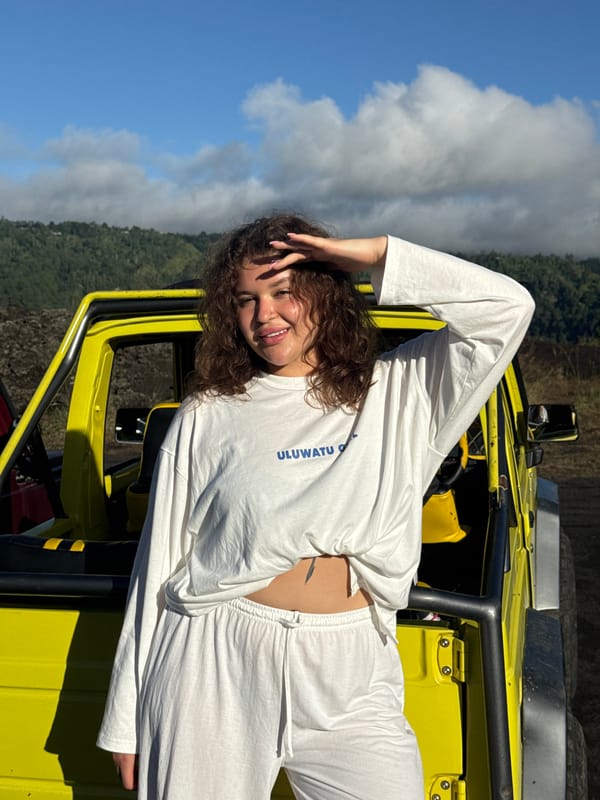 Woman poses with yellow jeep in Kintamani mountains