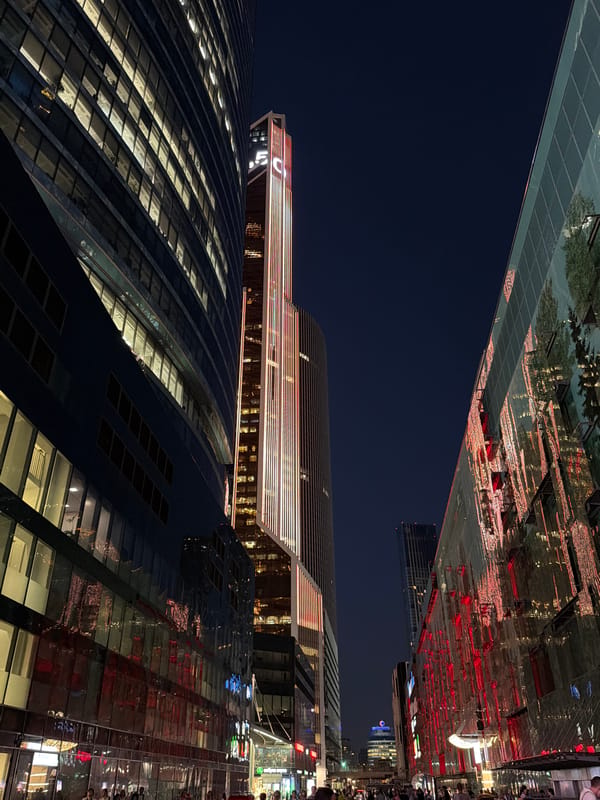 Moscow City's glass towers lit up after dark