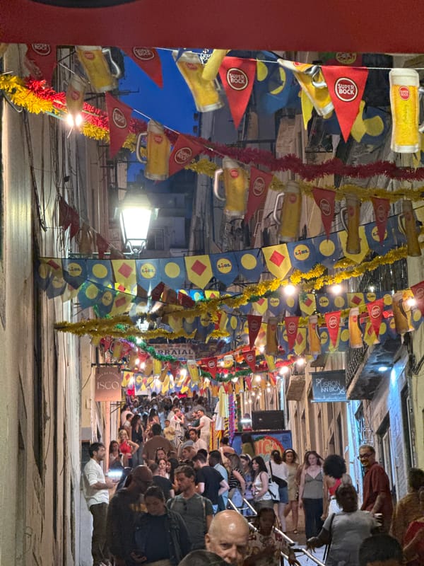 Lisbon festival night: crowded streets, classic car, summer arraial vibes