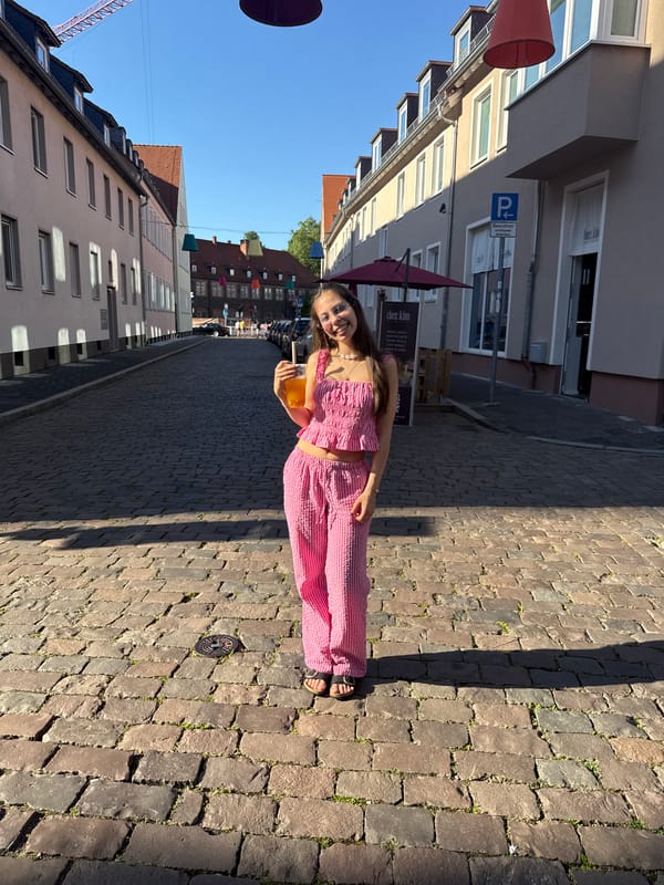 Young women enjoy beverages on Hanau street