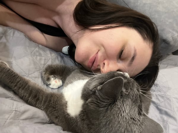 Woman and tuxedo cat share quiet domestic moments in Tyumen