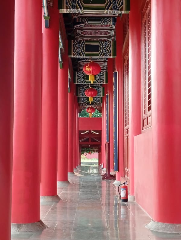 Visitors document Buddhist temples and statues in Lumbini, Nepal