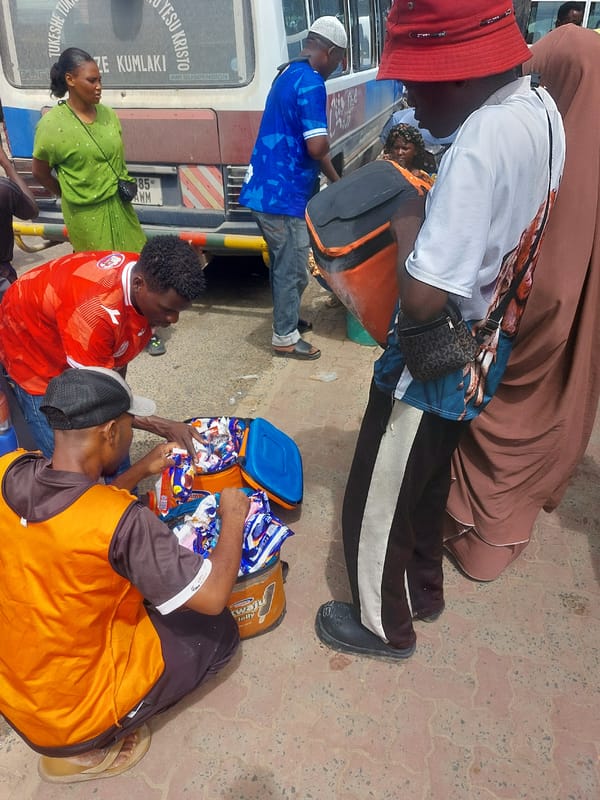 Street vendors serve customers at busy Dar es-Salaam transport hub