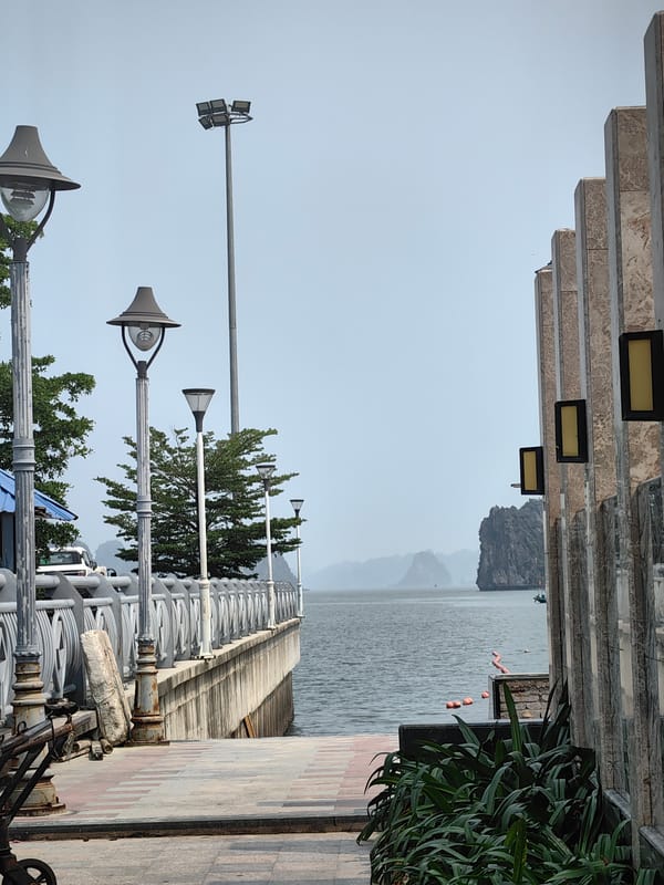 Couple documents early morning beach visit in Ha Long Bay