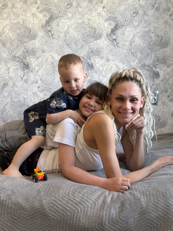 Mother and children share quiet moment in Zavolzhye home