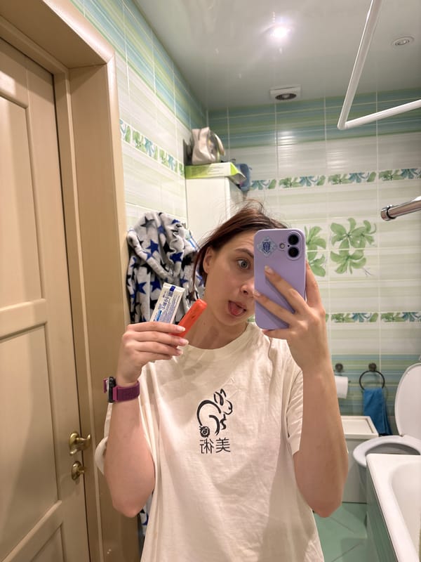 Person takes bathroom selfies with purple phone and lipstick