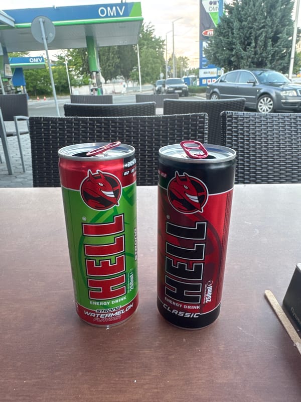 Person enjoys energy drinks at Bulgarian café near gas station