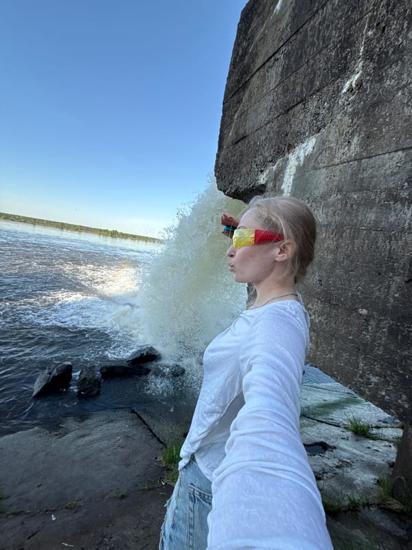 People gather at waterfall structure in rural Russia
