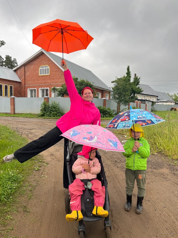 Overcast morning in Chaikovsky, colorful jackets and an orange umbrella