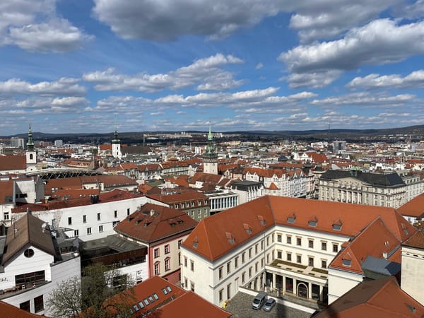 Aerial view captures Brno's red rooftops under clear skies