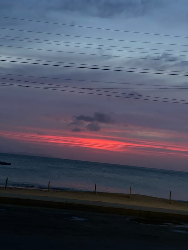 Uniformed personnel and civilians gather on Juan Griego beach