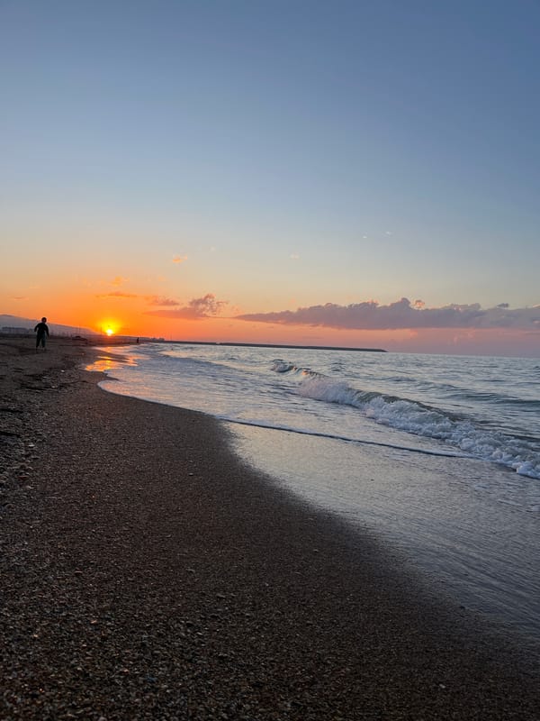Boy enjoys Caspian sunset on Kaspiysk beach