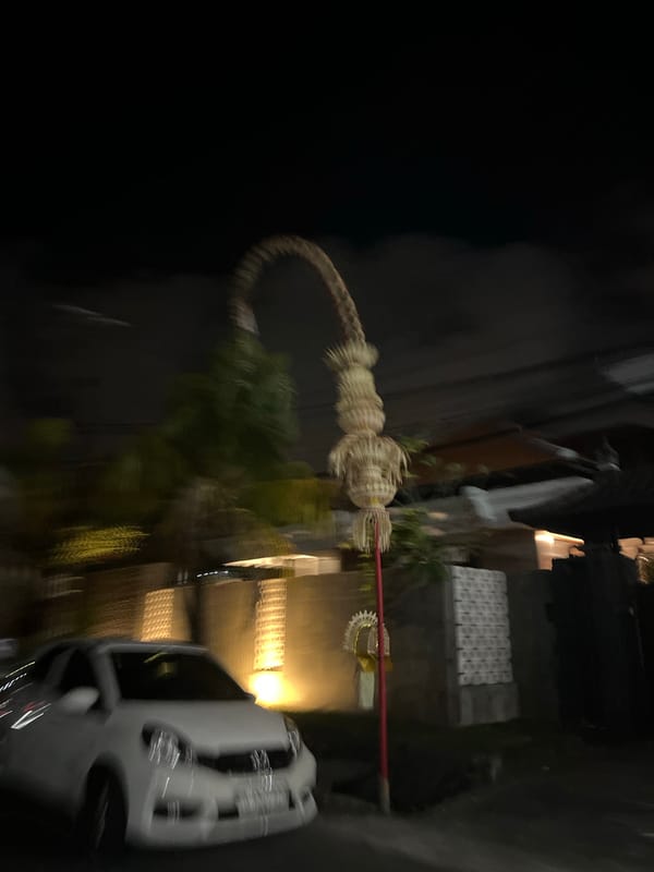 Nighttime scooter ride past ogoh-ogoh celebrations in Denpasar