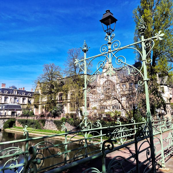 Tourist captures Strasbourg street scenes including canal bridge, graffitied bench