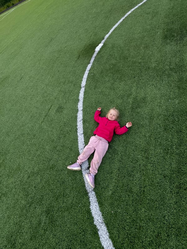 Mother and child play on Russian sports field